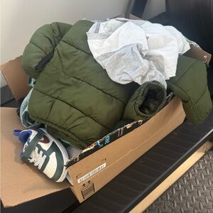Box of slightly used baby cloths.